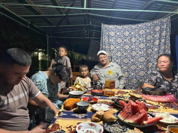 Feasting with an Uzbek family in tapchan traditional pavilion 