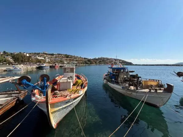 photo of fishing boats in the little port of agioi apostoloi village on euboea island, greece