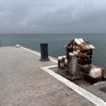 photo of stone fountain right in front of the sea in agios georgios lichadas coastal village on euboea island, greece