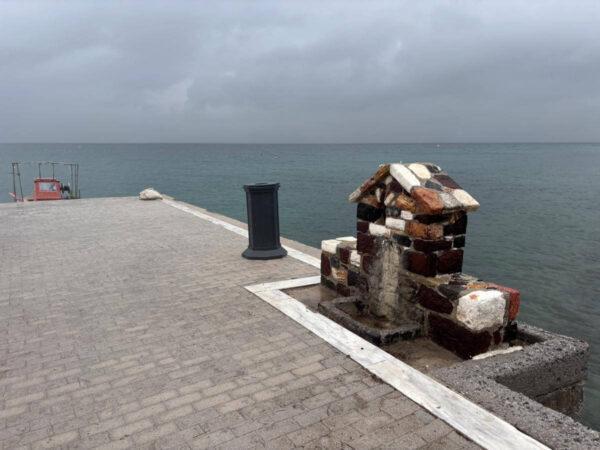 photo of stone fountain right in front of the sea in agios georgios lichadas coastal village on euboea island, greece