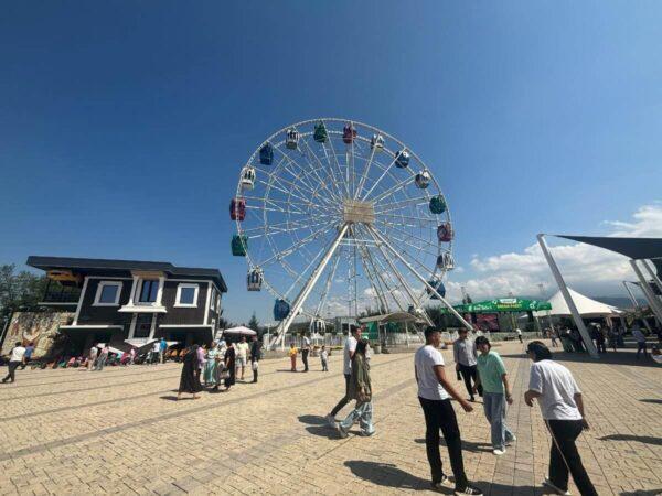 Ferris wheel and upside-down house on top of Kok Tobe Hill