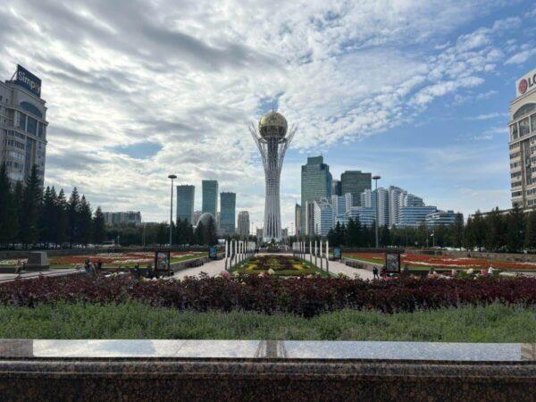 View of Baiterek Tower over neat flowerbeds in astana