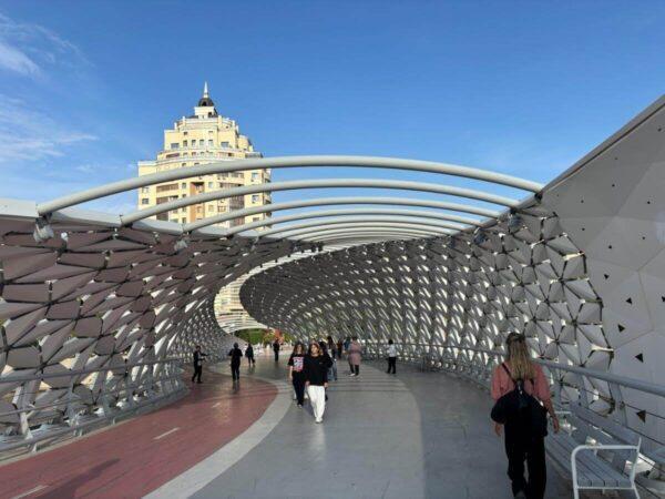 Crossing the Atyrau pedestrian bridge in astana