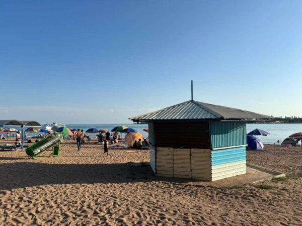 Vacationers on issyk kul lake beach of cholpon ata town in kyrgyzstan