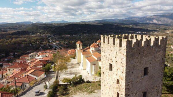 aerial photo of medieval tower and church in avlonari, euboea, greece