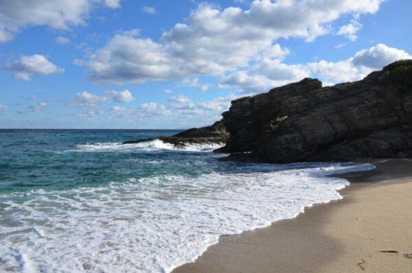 splashing waves at kalamos beach, evia island, greece