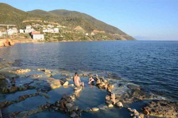 A hot bath before the sea in edipsos, evia island, greece