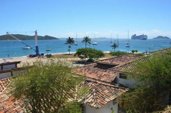 view of sea over old tile roofs in armacao dos buzios