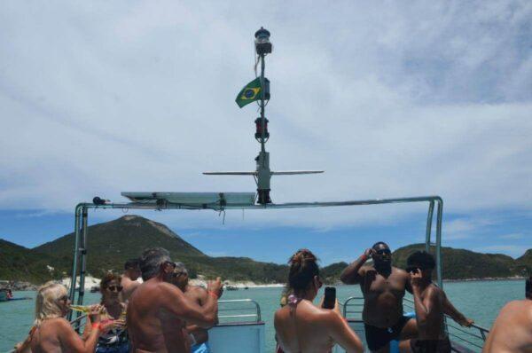 tourists On the upper deck of a tour boat in arraial do cabo