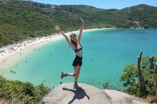 girl posing At the best viewpoint above Praia do Forno in arraial do cabo