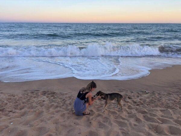 girl with dog on the beach of santa irene in rio das ostras, state of rio de janeiro, brazil